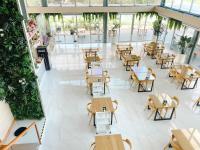 an empty restaurant with tables and chairs in a building at At Pream&Chan resort แอท เปรมแอนด์จันทร์ รีสอร์ท in Ban Krasang