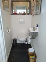 a bathroom with a toilet and a sink at The Lodge in Bilzen
