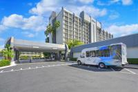 a bus parked in a parking lot in front of a building at Hilton Irvine/Orange County Airport in Irvine