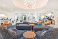a large living room with couches and chairs at Hilton Irvine/Orange County Airport in Irvine