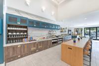 a large kitchen with blue cabinets and a counter at Hilton Irvine/Orange County Airport in Irvine