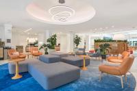 a lobby with couches and tables and chairs at Hilton Irvine/Orange County Airport in Irvine