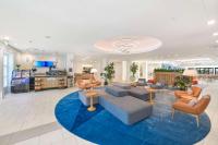 a lobby with couches and chairs on a blue rug at Hilton Irvine/Orange County Airport in Irvine