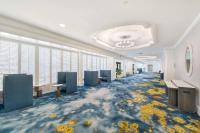 an office with a hallway with chairs and flowers on the floor at Hilton Irvine/Orange County Airport in Irvine