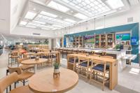 a restaurant with tables and chairs and a bar at Hilton Irvine/Orange County Airport in Irvine