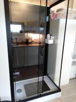 a shower with glass doors in a kitchen at The Lodge in Bilzen