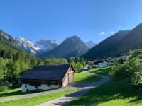 a barn in a valley with mountains in the background at Haus Kella-Egg in Brand