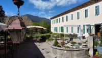 a courtyard with a fountain in front of a building at Hotel Carmel in Les Vans