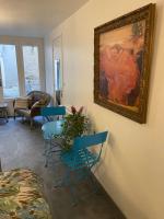 a living room with a table and chairs and a painting on the wall at Studio in Condom
