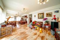 a living room with a hardwood floor and a living room with a christmas at Alps Garden B&amp;B in Wujie