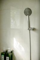 a shower in a bathroom with a shower head at Alps Garden B&amp;B in Wujie