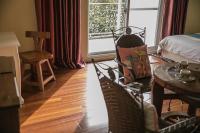 a room with a bed and a table and chairs at Alps Garden B&amp;B in Wujie