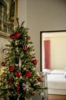 a christmas tree with ornaments on it in a room at Alps Garden B&amp;B in Wujie