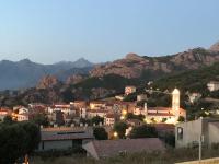 a view of a town with mountains in the background at Piana - vue mer et village in Piana