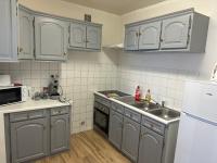 a kitchen with gray cabinets and a sink at Confortable appart 5 mins centre de valenciennes in Anzin