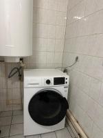 a kitchen with a washing machine in the corner at Confortable appart 5 mins centre de valenciennes in Anzin