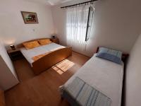 Postel nebo postele na pokoji v ubytování Apartmani Leila