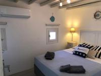 A bed or beds in a room at Anthos House
