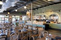 een restaurant met houten tafels en stoelen en een bar bij Modern Mansion in Lightsview By Host Solutions in Northfield