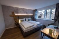 a bedroom with a bed and a cross on the wall at Hotel Adler in Stein am Rhein