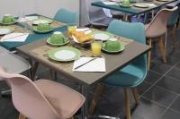 a table with plates and glasses of orange juice at City Lodge Appart Hôtel Niort in Niort