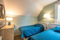 a bedroom with two beds and a window at Belle Dune in Fort-Mahon-Plage