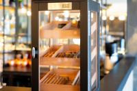 a refrigerator with its doors open in a store at Hôtel Mar I Cel &amp; Spa in Canet-en-Roussillon