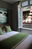 a bedroom with a large bed with a window at Le Mouton Blanc in Le Mont Saint Michel