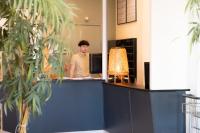 a man standing at a counter in an office at Hôtel Mar I Cel &amp; Spa in Canet-en-Roussillon