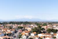 a view of a town with mountains in the background at Hôtel Mar I Cel &amp; Spa in Canet-en-Roussillon