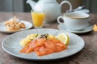 a plate of food with salmon and a cup of coffee at Burleigh Court Hotel in Stroud