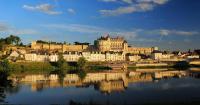 a large castle sitting next to a large body of water at HALTE 3 &#47; GUÈS DE VEIGNE in Veigné