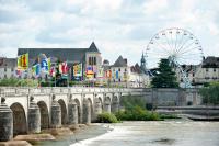 a bridge over a river with a bunch of flags at HALTE 3 &#47; GUÈS DE VEIGNE in Veigné