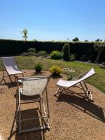 two lawn chairs sitting next to each other in a yard at Aurefees in Ellon