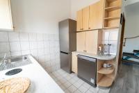 a small kitchen with a sink and a refrigerator at Apartment Kodi in Privlaka