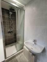 a bathroom with a sink and a glass shower at Chambre avec douche privative in Angers