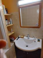 a bathroom with a sink and a mirror at Les Airelles 33, Le coin, Molines en Queyras Classé 3 étoiles in Molines-en-Queyras