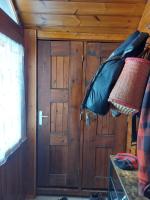 a room with wooden doors in a cabin at Les Airelles 33, Le coin, Molines en Queyras Classé 3 étoiles in Molines-en-Queyras