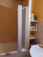 a shower with a glass door in a bathroom at Les Airelles 33, Le coin, Molines en Queyras Classé 3 étoiles in Molines-en-Queyras