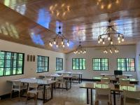 a dining room with tables and chairs and chandeliers at 南苑莊園 NanYuan Resort Manor in Nanzhuang