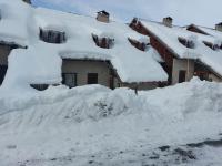a pile of snow in front of a house at Les Airelles 33, Le coin, Molines en Queyras Classé 3 étoiles in Molines-en-Queyras