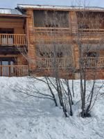 a log cabin in the snow with two trees at Les Airelles 33, Le coin, Molines en Queyras Classé 3 étoiles in Molines-en-Queyras