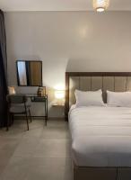 a bedroom with a bed and a chair and a television at Assalama Residency city center by TCE in Agadir