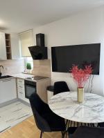 a kitchen with a table with chairs and a tv at Mila’s place in Zagreb