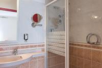 a bathroom with a sink and a shower at Hotel Bristol in Chalons en Champagne