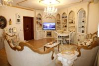 a living room with a table and a tv at Dream House Enia 2 in Shkodër