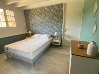 Łóżko lub łóżka w pokoju w obiekcie Gîte du Louvanto