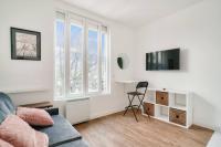 a white living room with a couch and a desk at Studette 4 calme et Lumineux, entièrement équipée in Créteil