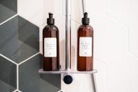 two bottles on a shelf in a bathroom at L&#39;Orée du Faubourg - VENDOME CENTRE in Vendôme