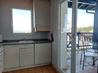 a kitchen with a sink and a view of a patio at Appartement Urrugne, 3 pièces, 6 personnes - FR-1-239-772 in Urrugne